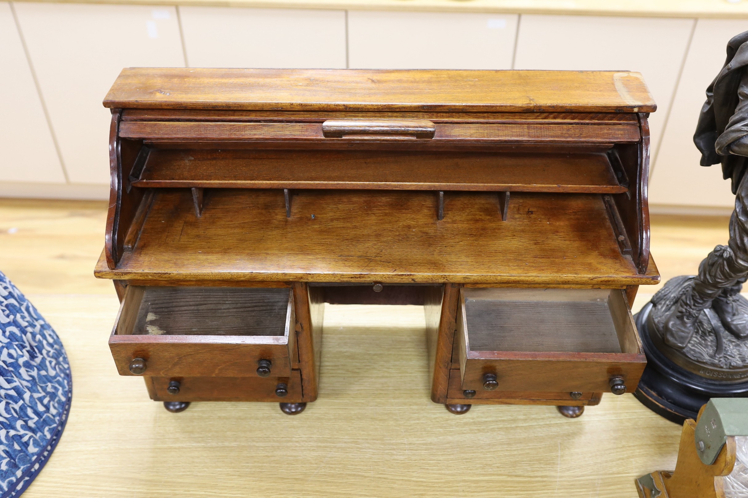 An early 20th century miniature beech tambour pedestal desk, possibly an apprentice piece, 67cms wide x 45cms high